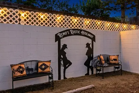 Hand-painted cowboy mural and two benches on the backyard wall
