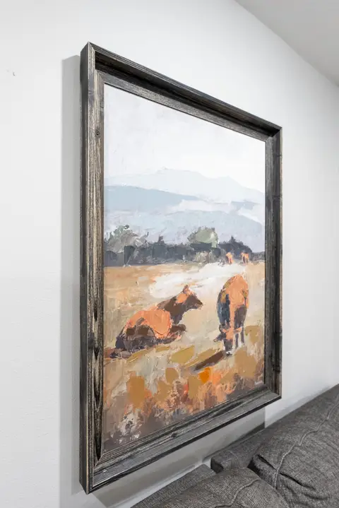Framed painting of cattle in a field