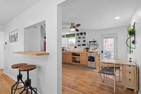 Bar stools at a pass-through counter between the living room and the kitchen