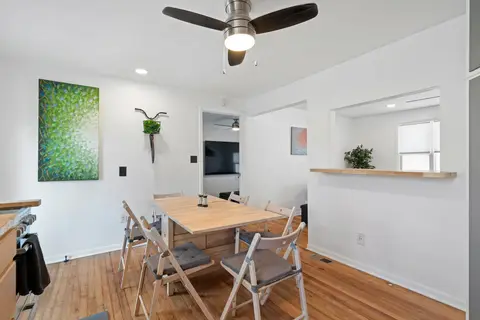 Dining table with folding chairs beside the pass-through to the living room