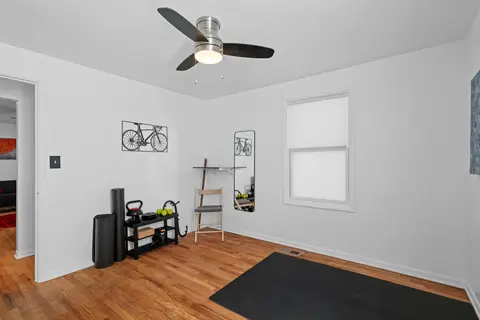 Workout corner with kettlebells, a foam roller, and a wall-mounted desk