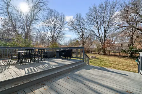 Deck dining set beside the railing, looking over the backyard