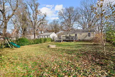 Backyard lawn with the swing set, looking back toward the house