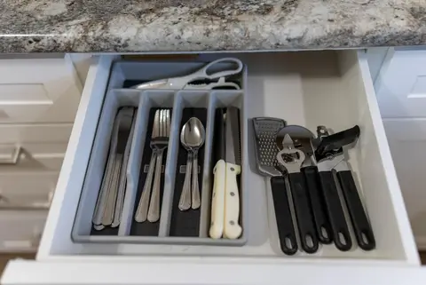 Cutlery tray with forks, knives, spoons, and kitchen tools
