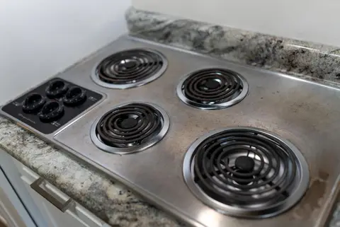 Electric coil cooktop set into the granite counter