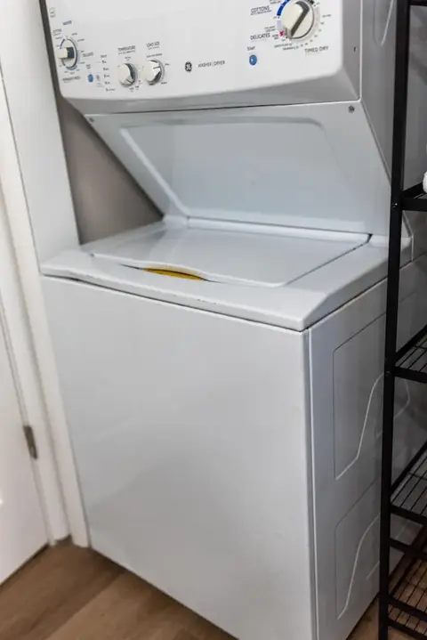 Top of the washer beside a black storage shelf