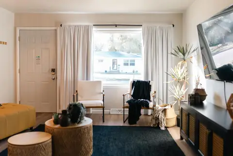 Two armchairs and round side tables by the front window