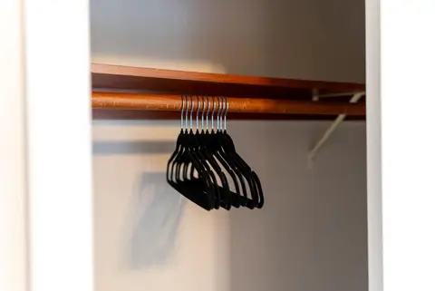 Black velvet hangers on a closet rod