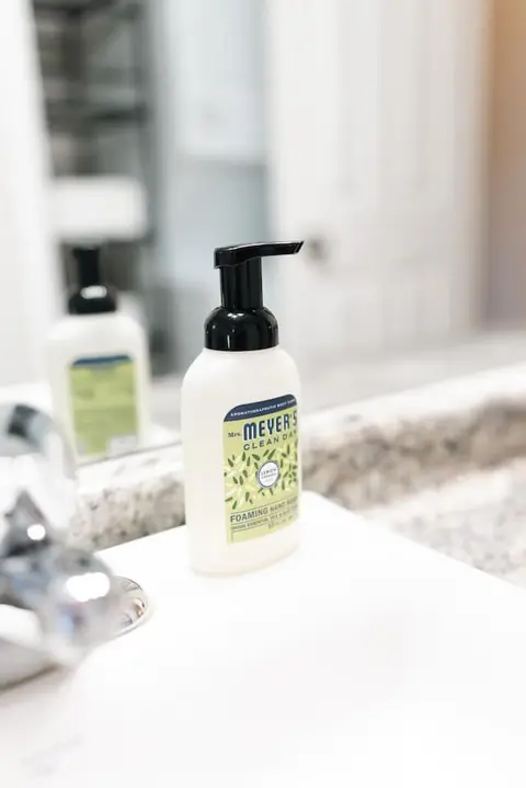 Foaming hand soap and lotion on a granite bathroom counter