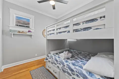 Full-size bunk beds with fish-print bedding and storage drawers