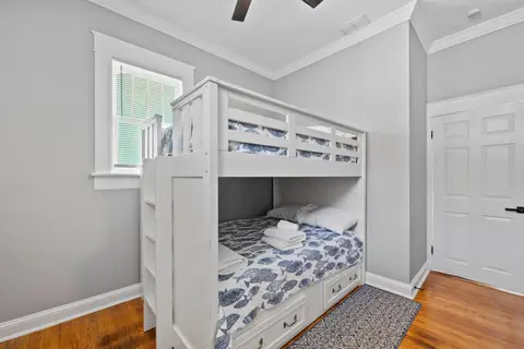 Bunk room with a ladder, fish-print bedding, and a closet