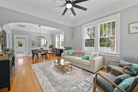 Open living area, with the dining table and the front door beyond