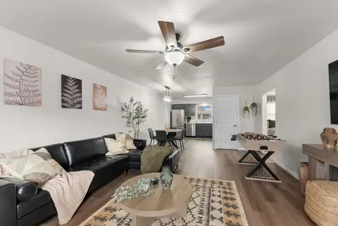 Living room with the sectional and foosball table, opening to the dining area and kitchen
