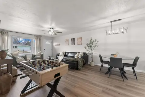 Foosball table in the living room, with the sectional and dining table behind