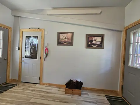 Entry room with framed prints and a crate of towels