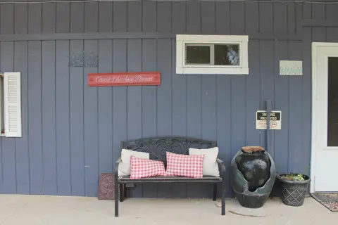 Bench with checked pillows against the blue building