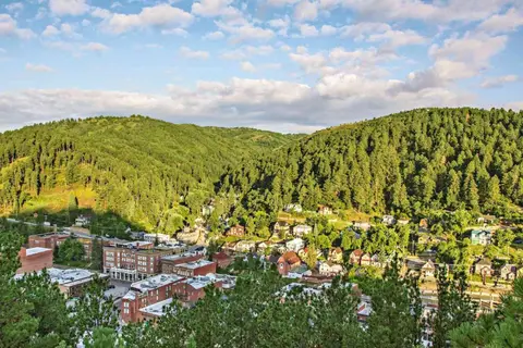 Deadwood from above, with green hills all around