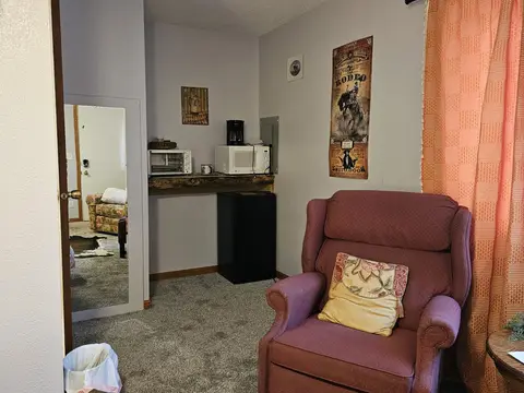 Recliner by the kitchenette, with a full-length mirror on the door