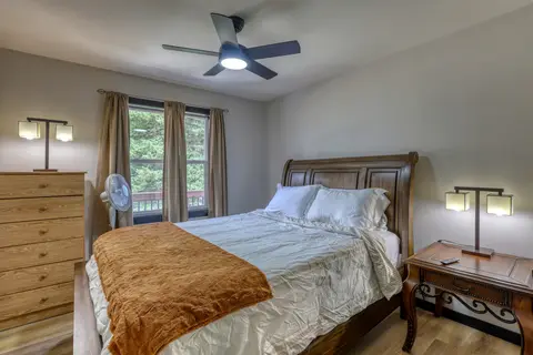 Second queen bedroom with a sleigh bed, a tall dresser, and two lamps