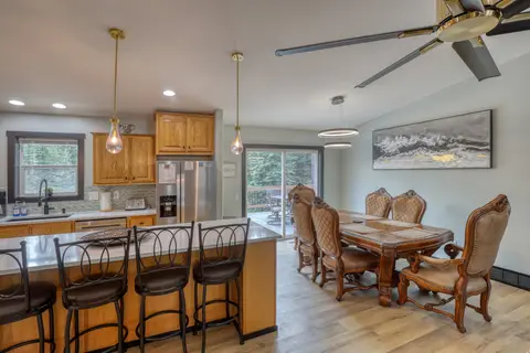 Island bar stools and the carved dining table by the deck door