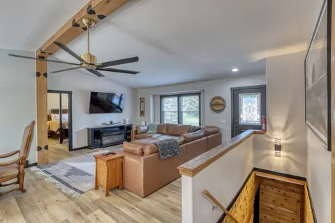 View from the top of the stairs across the living room to the front door