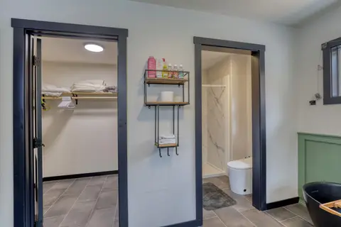 Walk-in closet beside a separate room with the toilet and shower