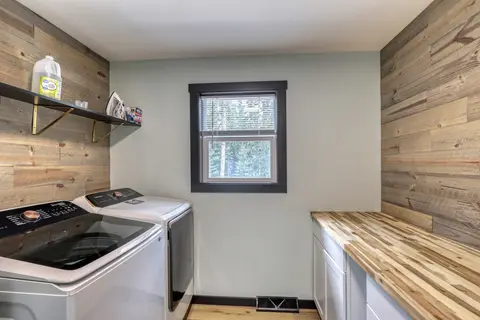 Laundry room with a washer, a dryer, and a wood folding counter