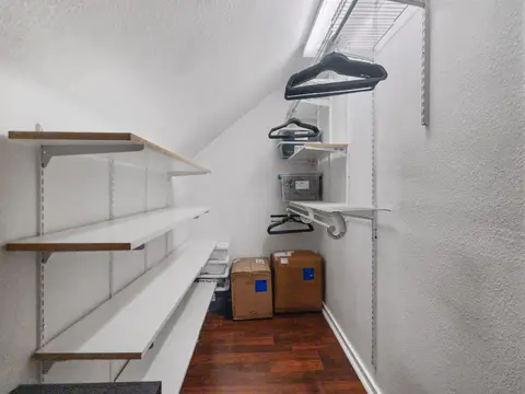Closet with open shelves and hangers