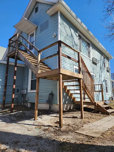 Exterior wooden staircase up to the apartment door