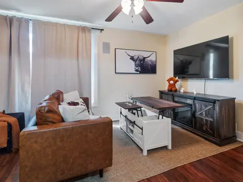 Living room with a lift-top coffee table and a wall-mounted TV