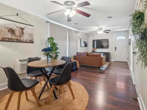 Dining nook with a round table, open to the living room and front door