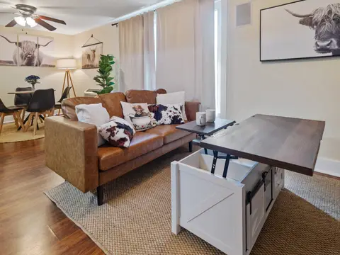 Leather sofa with cowhide pillows and a lift-top coffee table