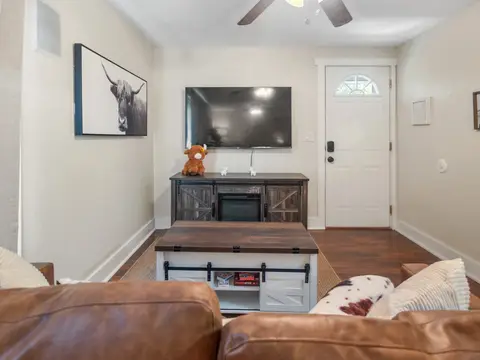 Wall-mounted TV over a console, seen from the sofa