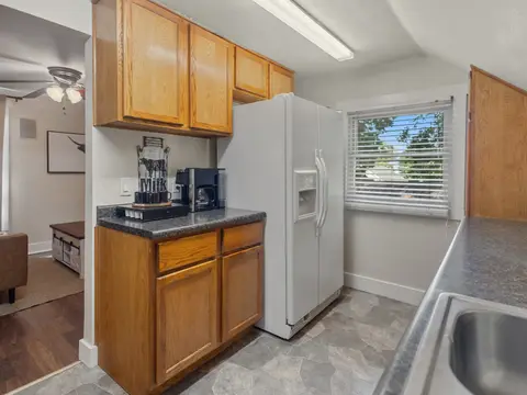 Kitchen corner with a white refrigerator and a coffee maker