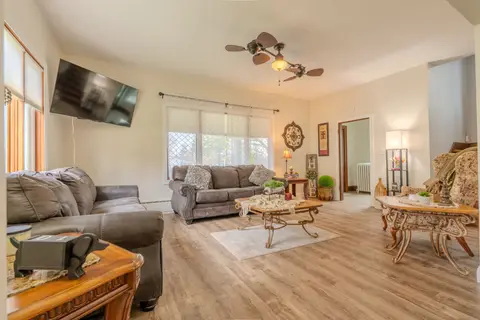 Living room with gray sofas, a coffee table, and a wall-mounted TV