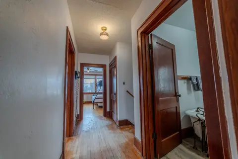 Upstairs hallway with wood doors and trim