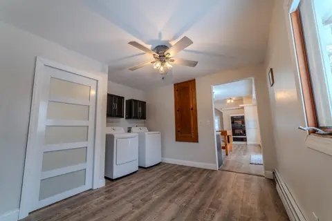 Laundry area with a washer and dryer beside a glass-panel door