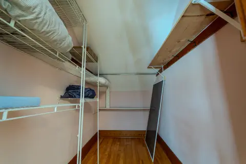 Walk-in closet with wire shelves and a hanging rod
