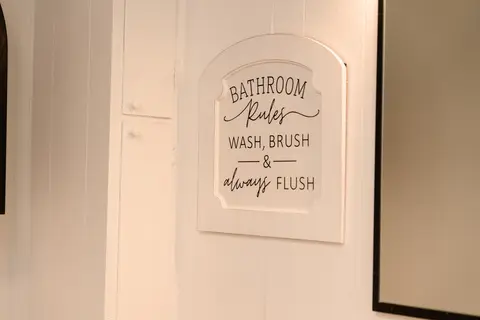 “Bathroom Rules” sign on a white wall