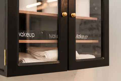 Glass-front cabinet with folded towels