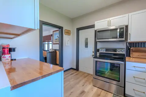 Butcher-block counter with a stainless range and microwave