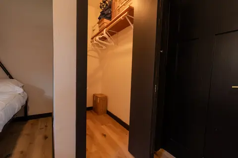 Walk-in closet with a hanging rod and shelf