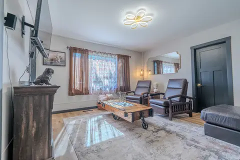 Living room with recliners, a cart-style coffee table, and a bulldog statue