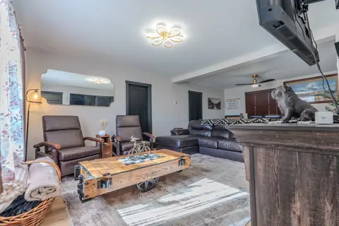 Two recliners and a cart-style coffee table near the front windows