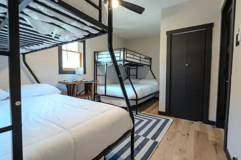 Two twin-over-full bunk beds, a side table, and a closet