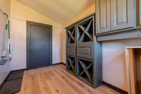 Mudroom with X-divided cubbies, drawers, and upper cabinets