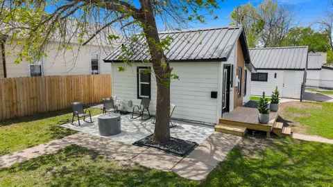 Side of the house with a patio, fire pit, and small wood deck