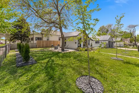 Lawn with young trees and the house beyond