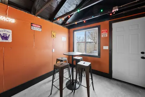 Bistro table and stools by the window in the shared game room
