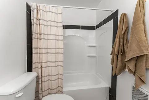 Tub and shower combination with a plaid curtain